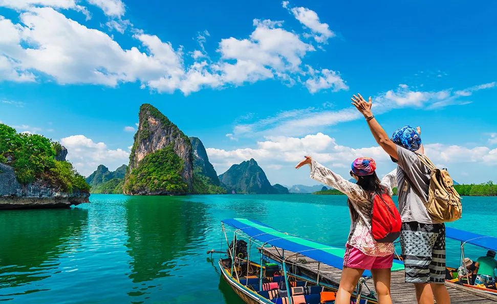 Travelers celebrating at a tropical island lagoon