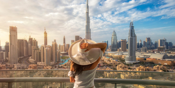 Traveler overlooking Burj Khalifa and the Dubai skyline